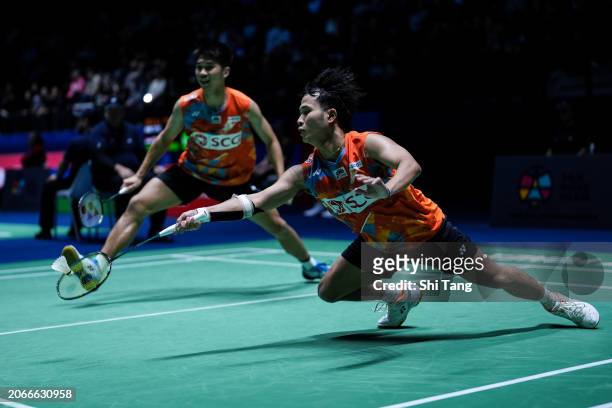 Supak Jomkoh and Kittinupong Kedren of Thailand compete in the Men's Doubles Second Round match against Liu Yuchen and Ou Xuanyi of China during day...