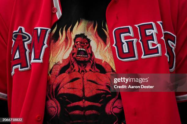 Fan is seen wearing a Hulk themed shirt under their Angels' jersey during a spring training game between the Los Angeles Angels and the Seattle...