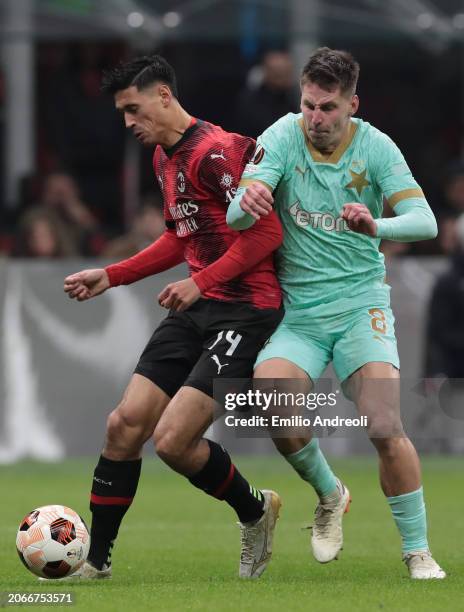 Tijjani Reijnders of AC Milan battles for the ball with Lukas Masopust of SK Slavia Praha during the UEFA Europa League 2023/24 round of 16 first leg...