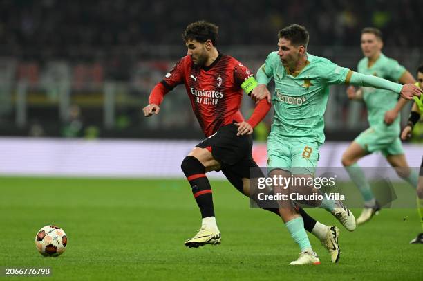 Theo Hernandez of AC Milan competes for the ball with Lukas Masopust with Slavia Praha during the UEFA Europa League 2023/24 round of 16 first leg...
