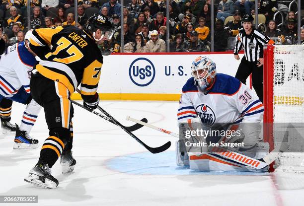 Calvin Pickard of the Edmonton Oilers makes a save on a shot by Jeff Carter of the Pittsburgh Penguins at PPG PAINTS Arena on March 10, 2024 in...