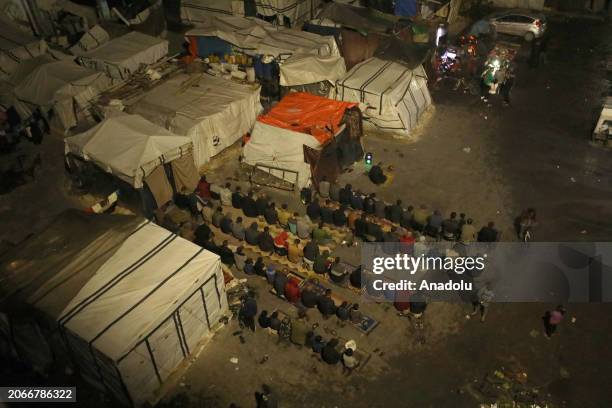 An aerial view of Palestinians performing the first taraweeh prayer of Ramadan near the tents amid Israeli attacks in Gaza City, Gaza on March 10,...