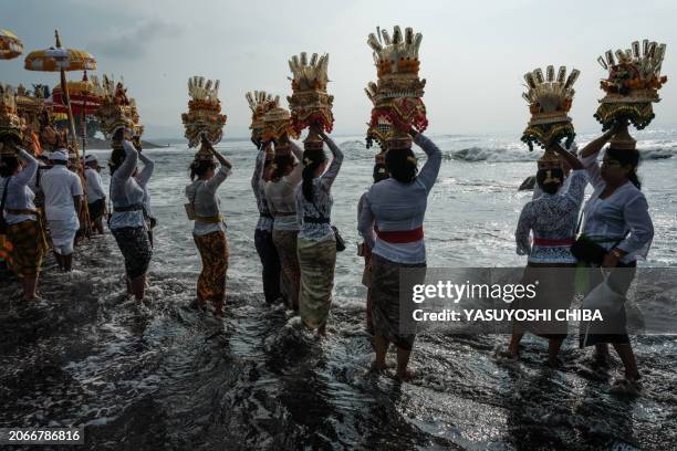 Balinese Hindus take part in a purification ritual known as Melasti, before Nyepi, the day of silence that marks the new year in the Balinese Hindu...