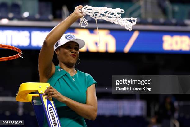 Head coach Niele Ivey of the Notre Dame Fighting Irish celebrates after cutting the net following their 55-51 victory against the NC State Wolfpack...