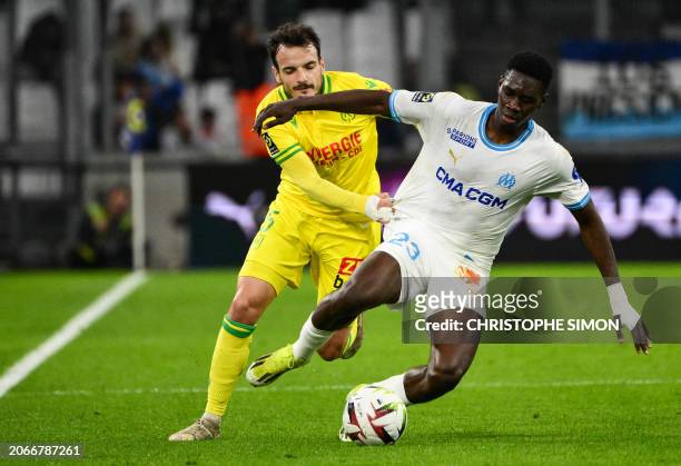 Nantes' Spanish midfielder Pedro Chirivella fights for the ball with Marseille's Senegalese forward Ismaila Sarr during the French L1 football match...