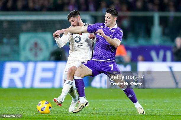 Riccardo Sottil of ACF Fiorentina and Houssem Aouar of AS Roma compete for the ball during the Serie A TIM match between ACF Fiorentina and AS Roma...