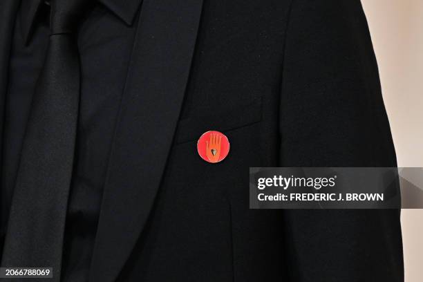 FIlm producer Nadim Cheikhrouha wears an "Artists4Ceasefire" pin, calling for de-escalation and ceasefire in Gaza and Israel, as he attends the 96th...