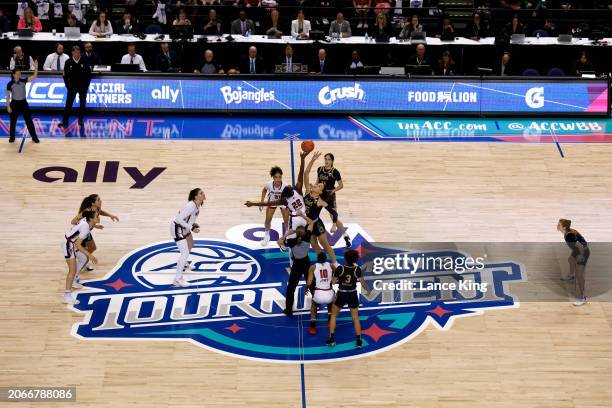 Saniya Rivers of the NC State Wolfpack and Natalija Marshall of the Notre Dame Fighting Irish jump for the ball during the opening tip of the ACC...