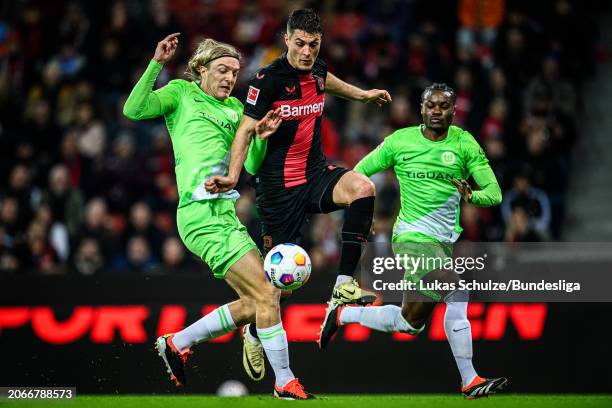 Sebastiaan Bornauw of Wolfsburg, Patrik Schick of Leverkusen and Ridle Baku of Wolfsburg in action during the Bundesliga match between Bayer 04...