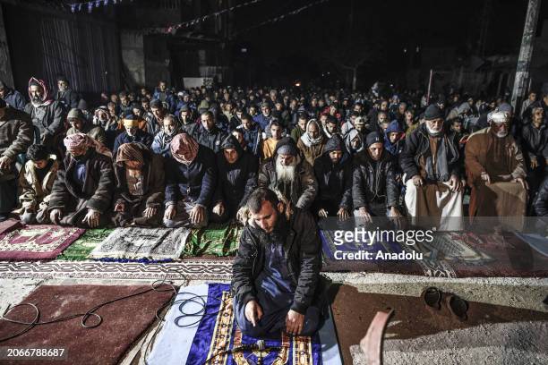 Palestinians perform the first taraweeh of Ramadan on the rubble of Farouk Mosque, which destroyed in the Israeli attack, in Rafah, Gaza on March 10,...