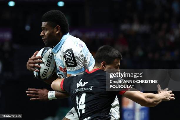 Racing92's Fijian wing Wame Naituvi vies with Toulon's French wing Gael Drean during the French Top14 rugby union match between Racing92 and Toulon...