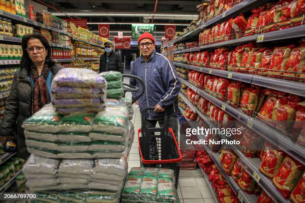 Tunisian customers are shopping for food at a supermarket in the Ariana district in Tunis, Tunisia, on March 10, 2024. Tunisia is being hit by a...