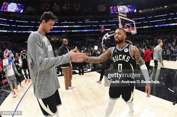 Danilo Gallinari greets Damian Lillard of the Milwaukee Bucks after the game against the LA Clippers on March 10, 2024 at Crypto.Com Arena in Los...