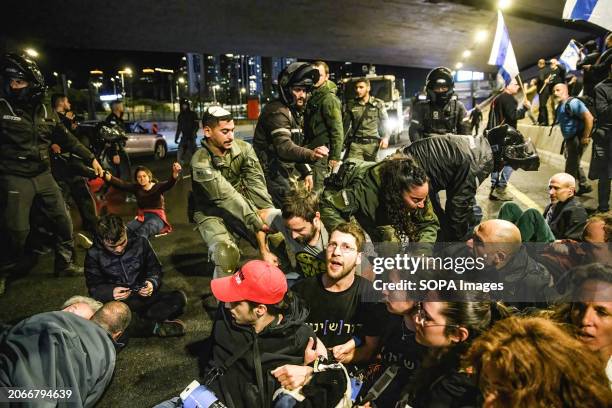 Israeli Police and Border Police soldiers disperse protestors from the Ayalon highway during the demonstration. Thousands of Israelis protested...