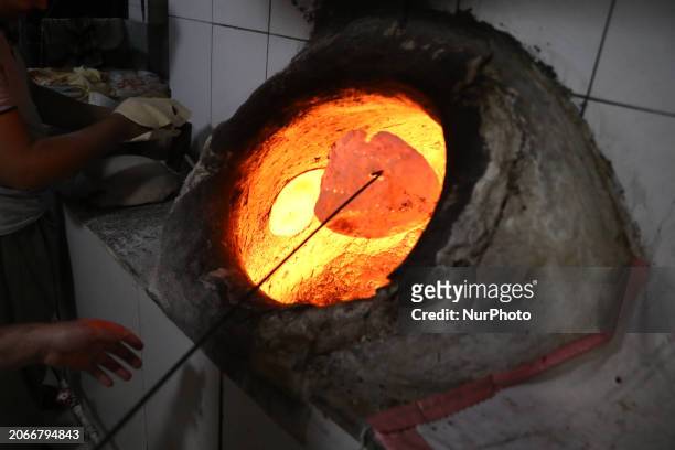 Workers make a traditional bread at a bakery in Manama, Bahrain on March 4, 2024.