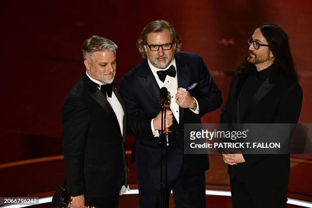 Writer and director Dave Mullins , US producer Brad Booker and US musician Sean Ono Lennon accept the award for Best Animated Short Film for "War is...