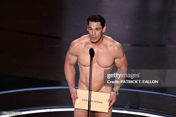 Actor John Cena presents the award for Best Costume Design onstage during the 96th Annual Academy Awards at the Dolby Theatre in Hollywood,...