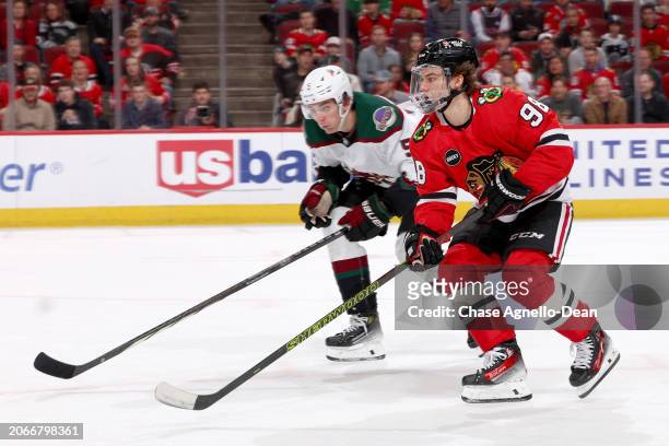 Connor Bedard of the Chicago Blackhawks and Michael Kesselring of the Arizona Coyotes skate in the second period at the United Center on March 10,...