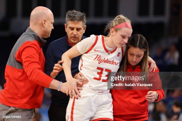 Head coach Mike McGuire of the Radford Highlanders and the athletic training staff help Ellie Taylor of the Radford Highlanders after an injury...