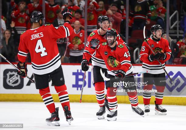 Colin Blackwell of the Chicago Blackhawks celebrates with teammates after scoring his third goal during the third period against the Arizona Coyotes...