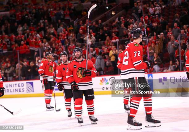 Colin Blackwell of the Chicago Blackhawks raises his raises his stick after a game against the Arizona Coyotes at the United Center on March 10, 2024...