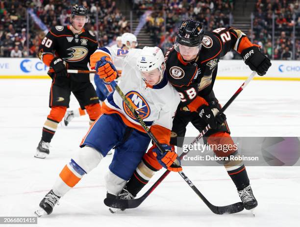 Kyle MacLean of the New York Islanders and Gustav Lindstrom of the Anaheim Ducks battle for position during the second period at Honda Center on...