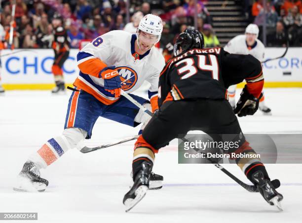 Pierre Engvall of the New York Islanders and Pavel Mintyukov of the Anaheim Ducks battle for the puck during the second period at Honda Center on...