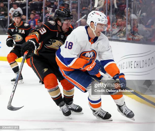 Mason McTavish of the Anaheim Ducks and Pierre Engvall of the New York Islanders battle for the puck during the second period at Honda Center on...