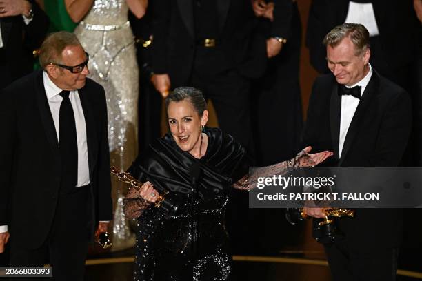 Producers of "Oppenheimer" British film producer Emma Thomas , US film producer Charles Roven and British filmmaker Christopher Nolan accept the...