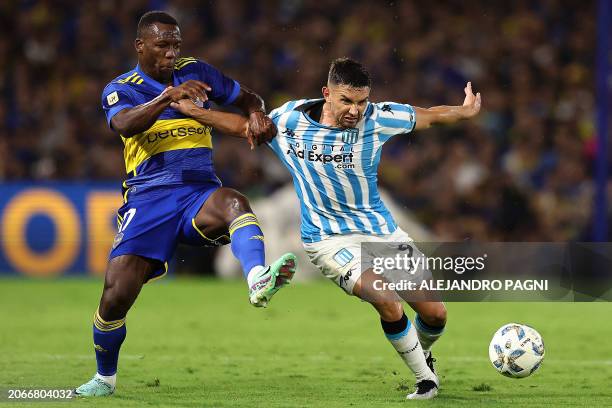 Racing Club's forward Adrian Martinez fights for the ball with Boca Juniors' Peruvian defender Luis Advincula during the Argentine Professional...