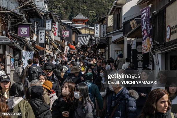 In this picture taken on March 10 people walk through a street near Kiyomizu-dera Temple in Kyoto.