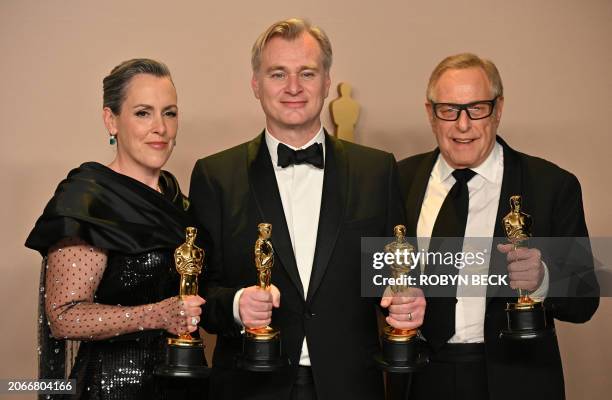British film producer Emma Thomas, US film producer Charles Roven, and British filmmaker Christopher Nolan pose in the press room with the Oscar for...