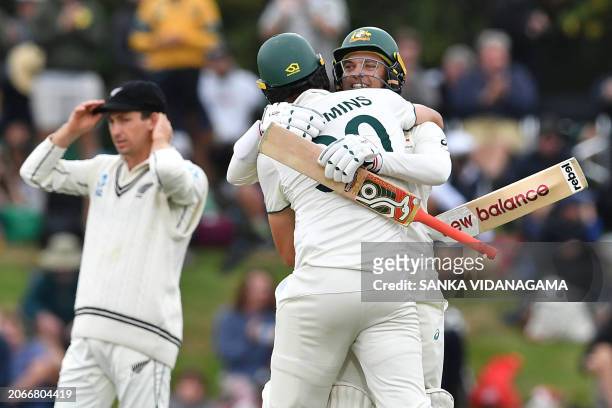 Australia's Pat Cummins and Alex Carey celebrate their victory on day four of the second Test cricket match between New Zealand and Australia at...