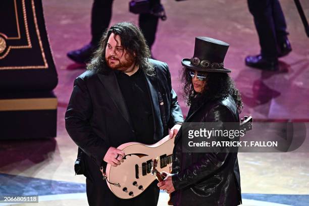 British-US musician Slash and US musician Wolfgang Van Halen perform "I'm Just Ken" from "Barbie" onstage during the 96th Annual Academy Awards at...