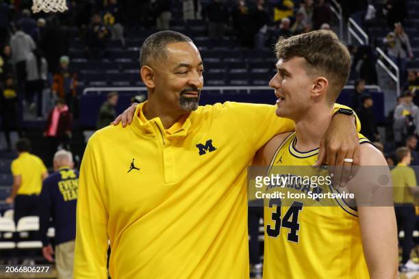 Michigan Wolverines head coach Juwan Howard smiles at Michigan Wolverines forward Jackson Selvala as they walk off of the court at the end of a Big...