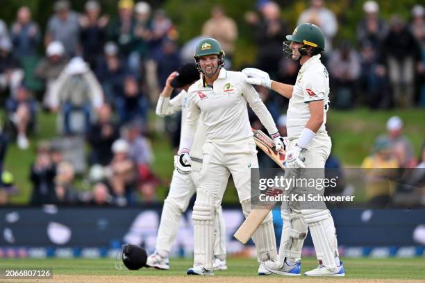 Alex Carey and Pat Cummins of Australia celebrate their win during day four of the Second Test in the series between New Zealand and Australia at...