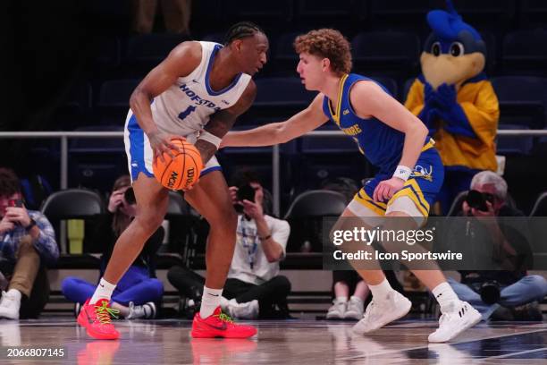 Hofstra Pride Guard Darlinstone Dubar looks to make a move on Delaware Blue Hens Guard Cavan Reilly during the first half of the CAA Men's Basketball...