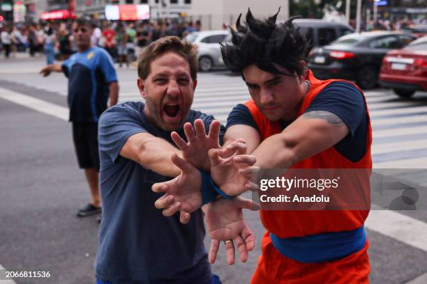 Men wearing cartoon character costume pose for a photo as hundreds of Dragon Ball fans, a Comic created by Akira Toriyama, gather at Plaza del...