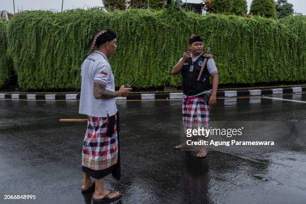 Two Balinese traditional securities called Pecalang patrolling during the day of silence of Nyepi Day on March 11, 2024 in Jimbaran beach, Bali,...
