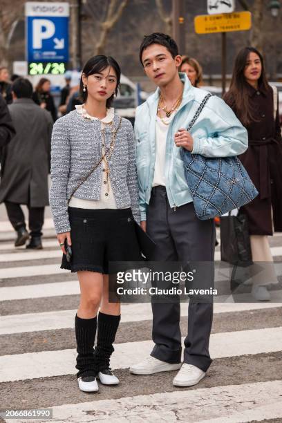 Yaqian Lan wears light blue tweed jacket, black mini. Skirt, black leg warmers, white ballet flats, outside Chanel, during the Womenswear Fall/Winter...