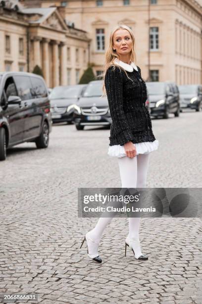 Tatiana Korsakova wears black tweed mini dress, white tights, black News  Photo - Getty Images