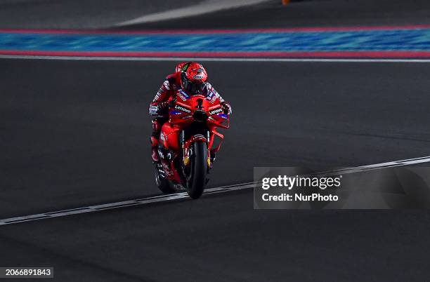 Italian MotoGP rider Francesco Bagnaia of the Ducati Lenovo Team is cutting the finish line and celebrating his victory on the podium at the end of...