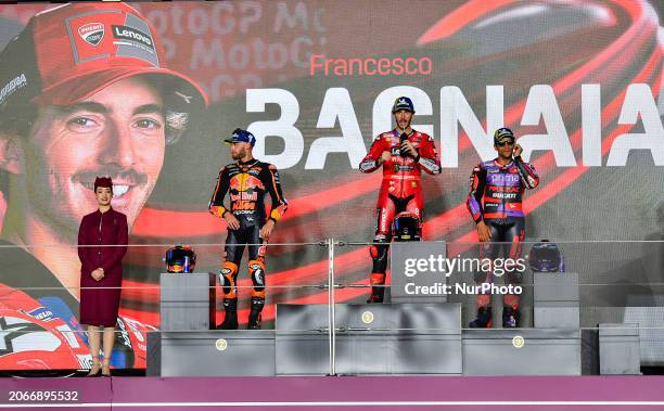 Italian MotoGP rider Francesco Bagnaia of Ducati Lenovo Team is celebrating his first-place finish on the podium, alongside South African MotoGP...