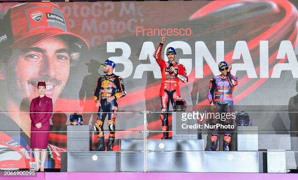 Italian MotoGP rider Francesco Bagnaia of Ducati Lenovo Team is celebrating his first-place finish on the podium, alongside South African MotoGP...