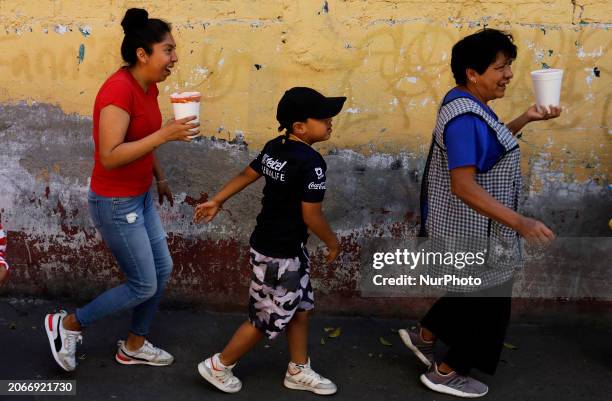 Three people are heading to the Carnival and Mask Festival in San Francisco Culhuacan, Mexico City, on the eve of the Holy Week celebrations in the...