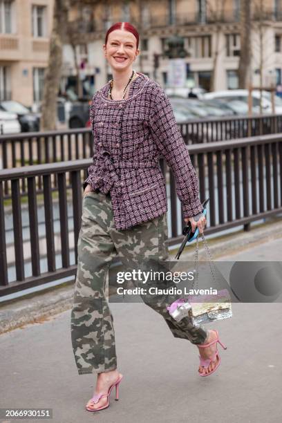 Marianne Theodorse wears pink tweed jacket, military print pants, sequins Chanel bag, pink heels, outside Chanel, during the Womenswear Fall/Winter...