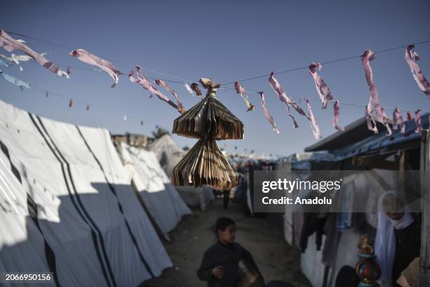 Usfur family makes colorful ornaments and decorates makeshift tents to cheer up children within Ramadan celebrations despite ongoing Israeli attacks...