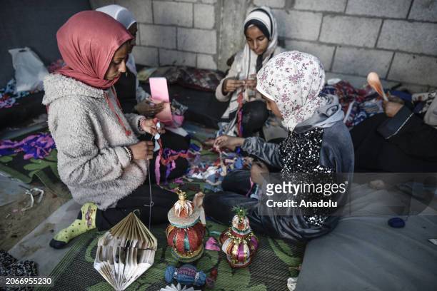 Usfur family makes colorful ornaments and decorates makeshift tents to cheer up children within Ramadan celebrations despite ongoing Israeli attacks...