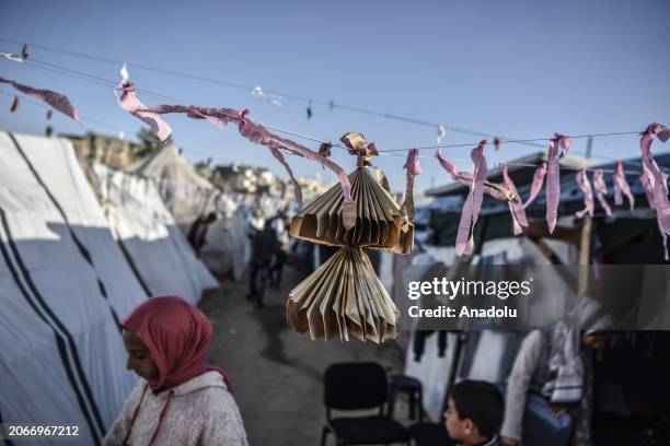 Usfur family makes colorful ornaments and decorates makeshift tents to cheer up children within Ramadan celebrations despite ongoing Israeli attacks...