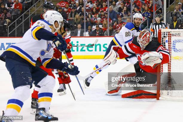 Nico Daws of the New Jersey Devils makes the first period save on Brayden Schenn of the St. Louis Blues at Prudential Center on March 07, 2024 in...